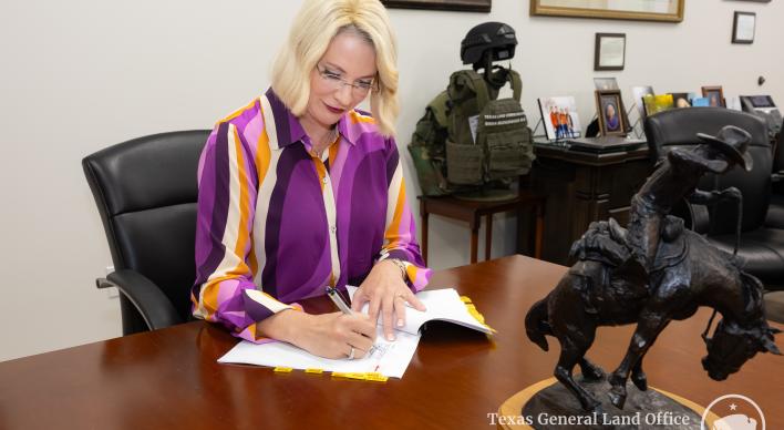 Texas Land Commissioner Dawn Buckingham, M.D., signs paperwork for hotel acquisition