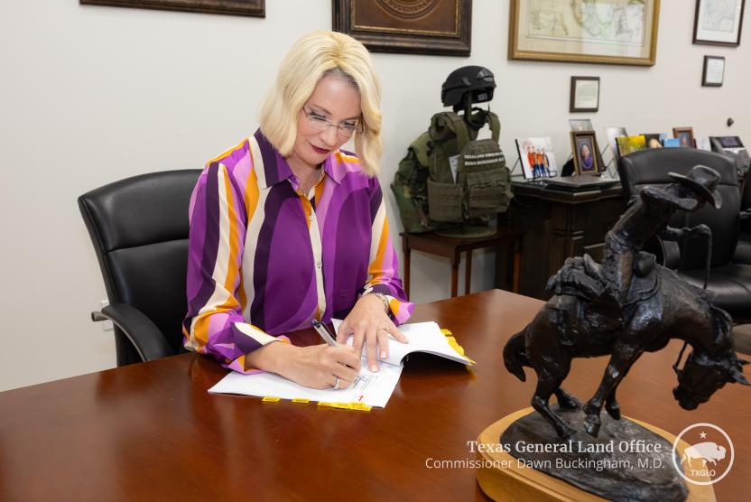 Texas Land Commissioner Dawn Buckingham, M.D., signs paperwork for hotel acquisition