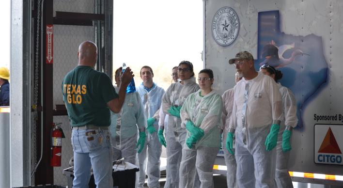 A GLO employee briefing oil spill cleanup volunteers.
